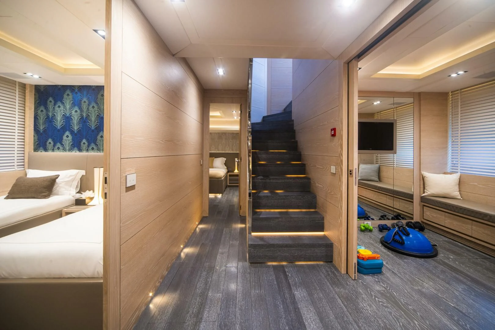 a room with a bed and a staircase aboard FAST & FURIOUS Yacht for Charter