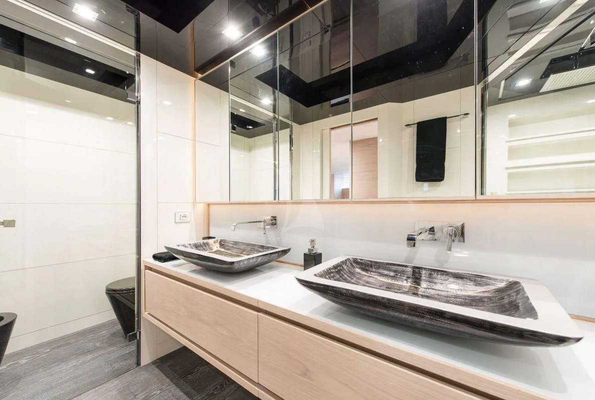 a bathroom with a sink and a mirror aboard FAST & FURIOUS Yacht for Charter