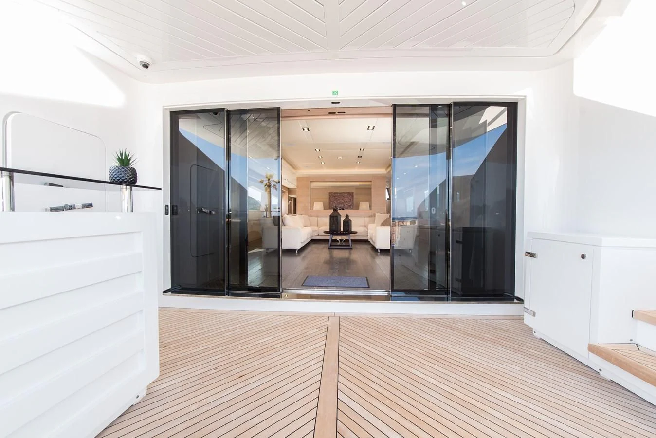 a room with a wood floor and black doors aboard FAST & FURIOUS Yacht for Charter
