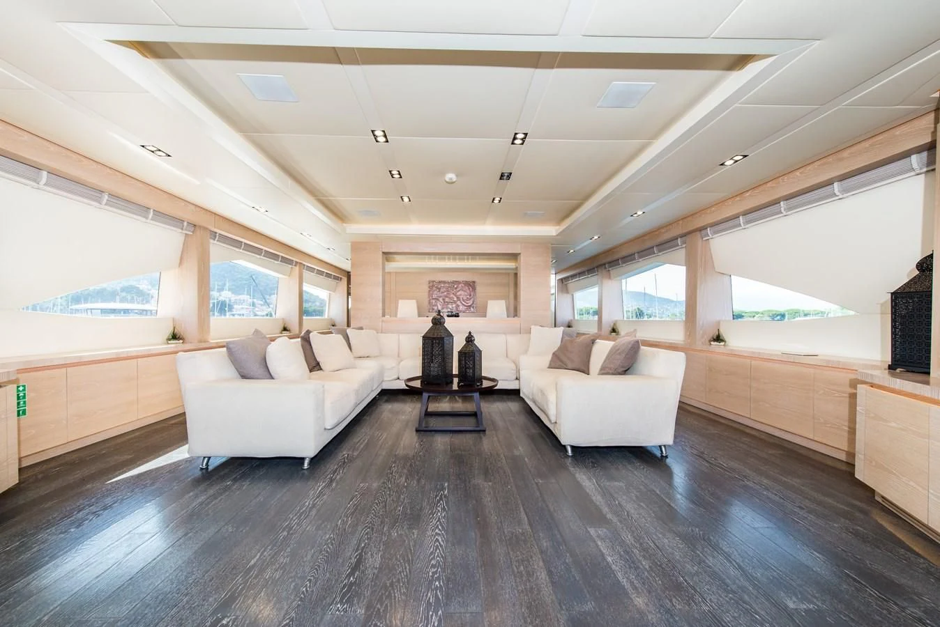a large living room with a wood floor aboard FAST & FURIOUS Yacht for Charter