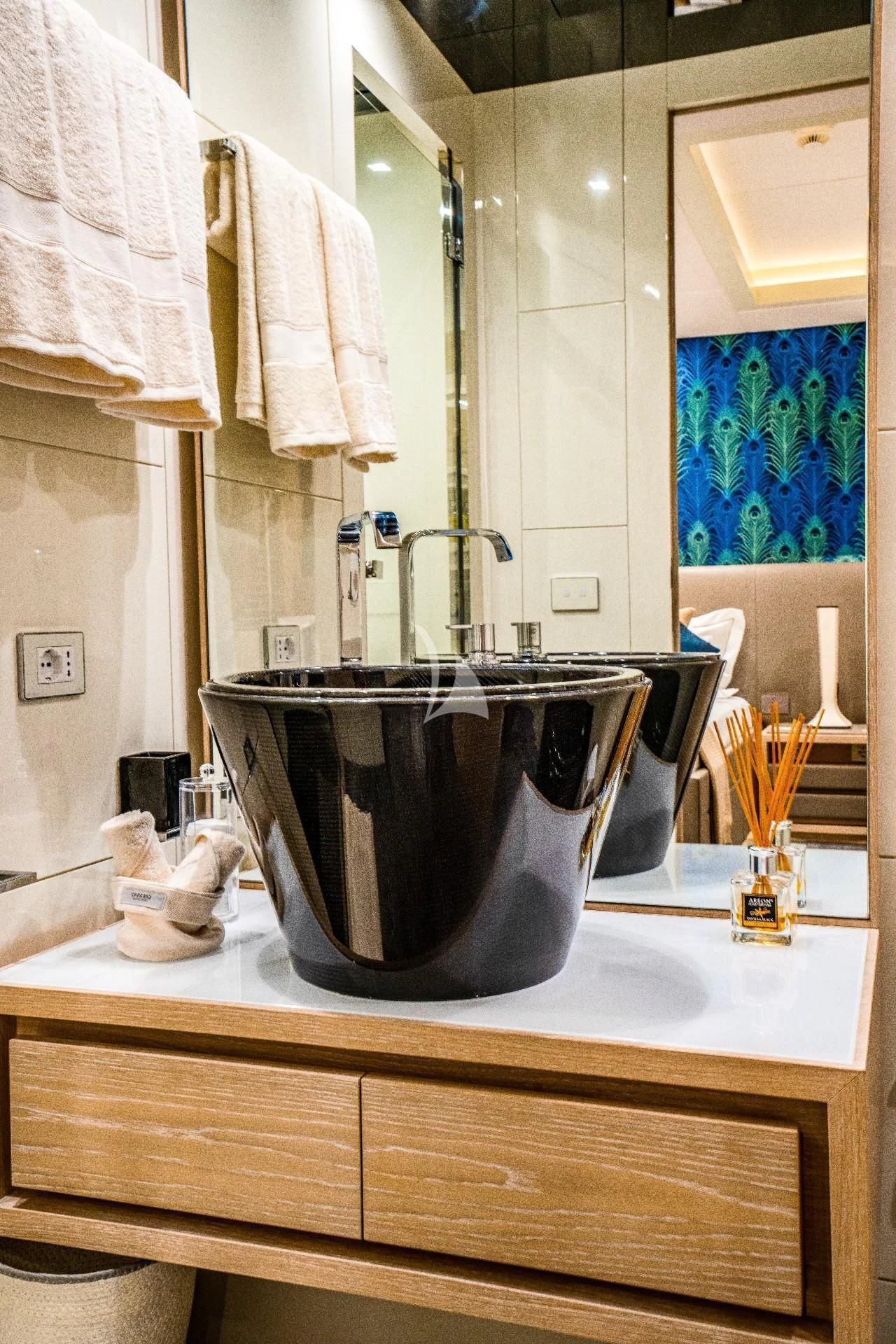 a bathroom with a large black bucket aboard FAST & FURIOUS Yacht for Charter