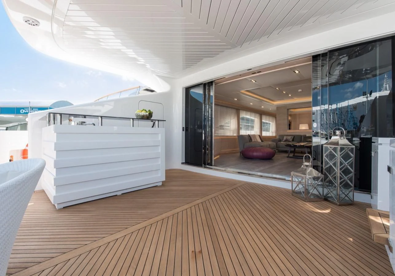 a room with a deck and a pool table aboard FAST & FURIOUS Yacht for Charter