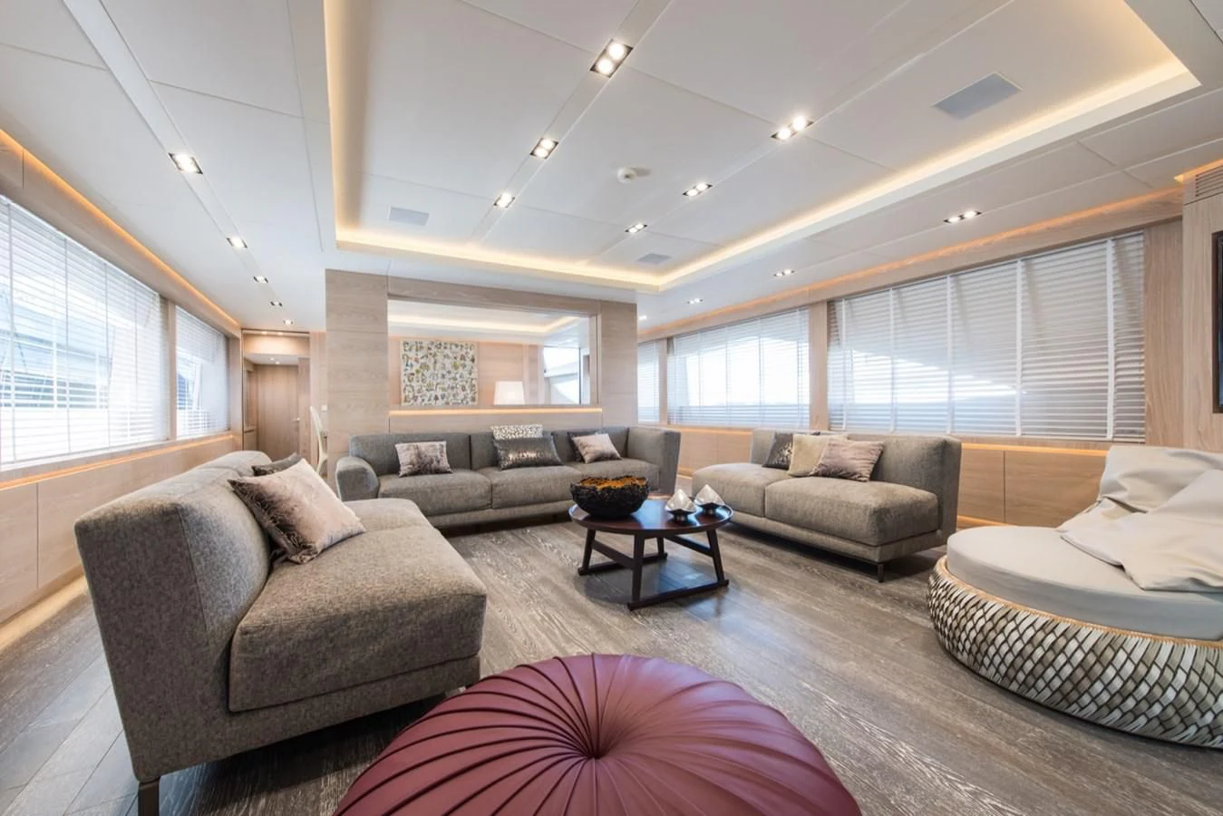 a living room with a couch and a large window aboard FAST & FURIOUS Yacht for Charter