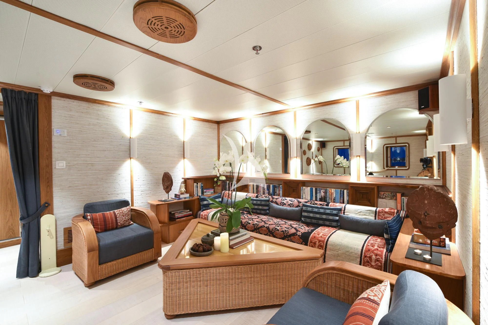 a living room with a large mirror aboard KUDANIL EXPLORER Yacht for Sale