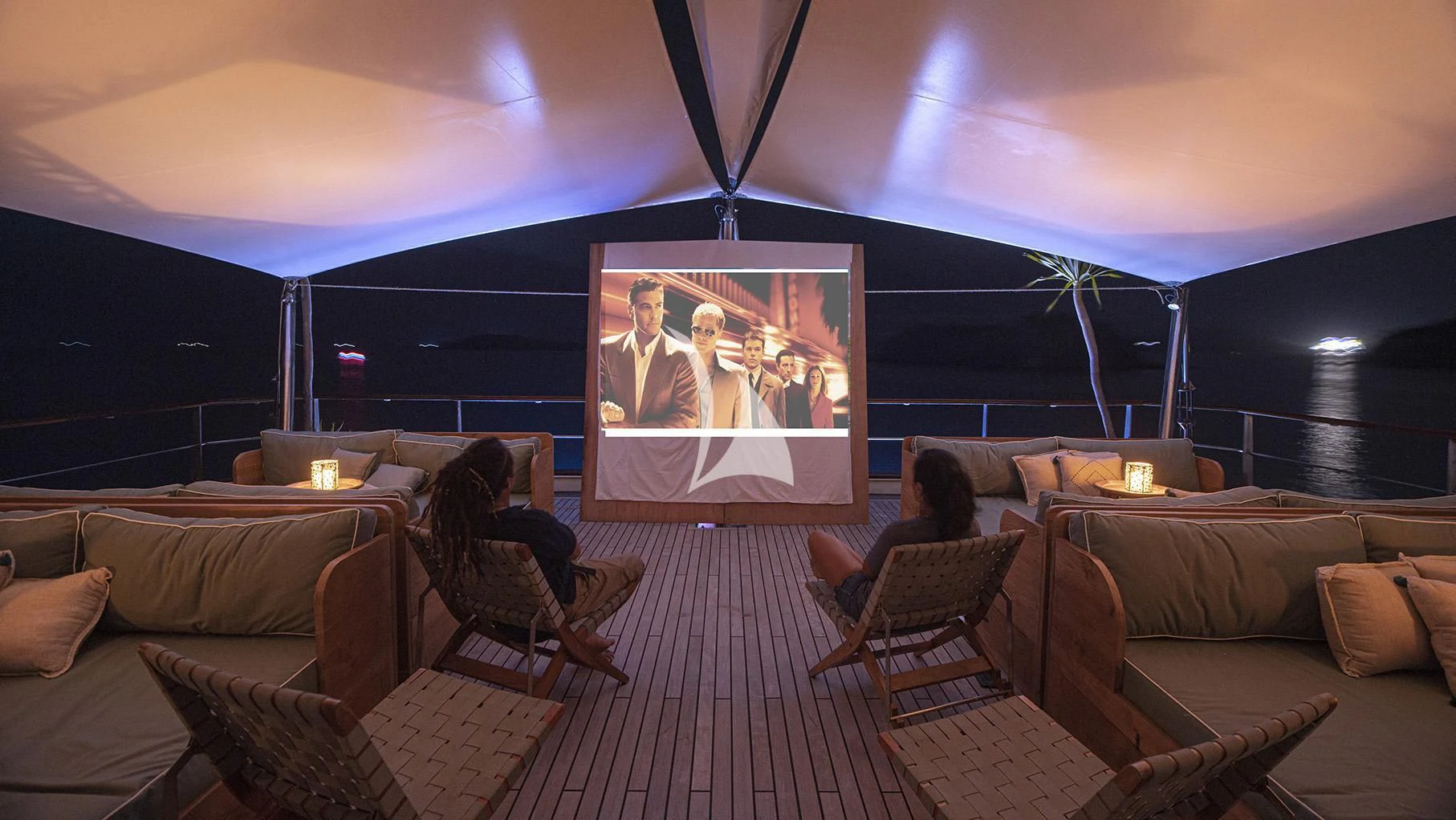 a couple sitting on a couch watching a tv aboard KUDANIL EXPLORER Yacht for Sale