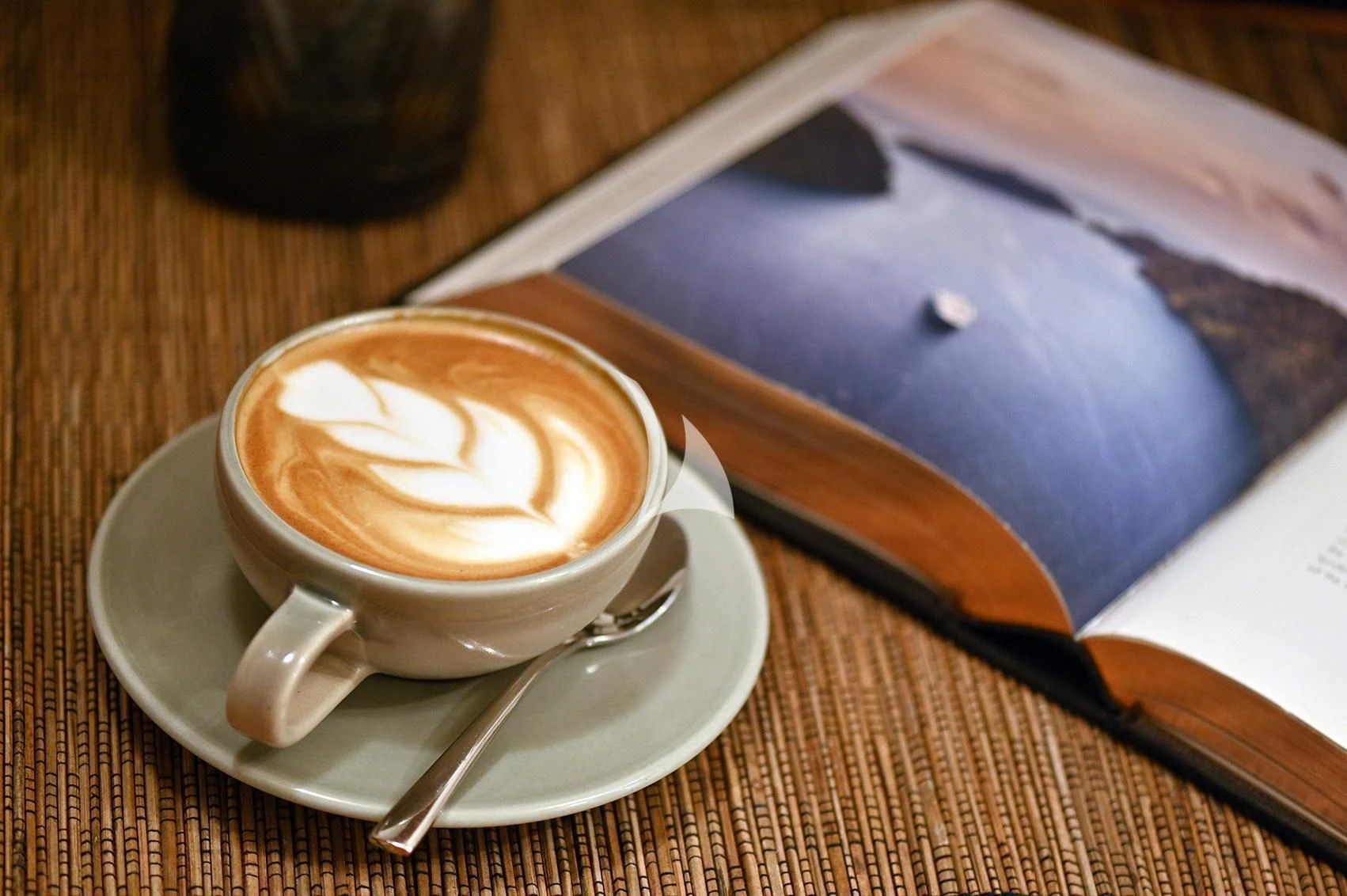 a cup of coffee on a saucer on a table aboard KUDANIL EXPLORER Yacht for Sale