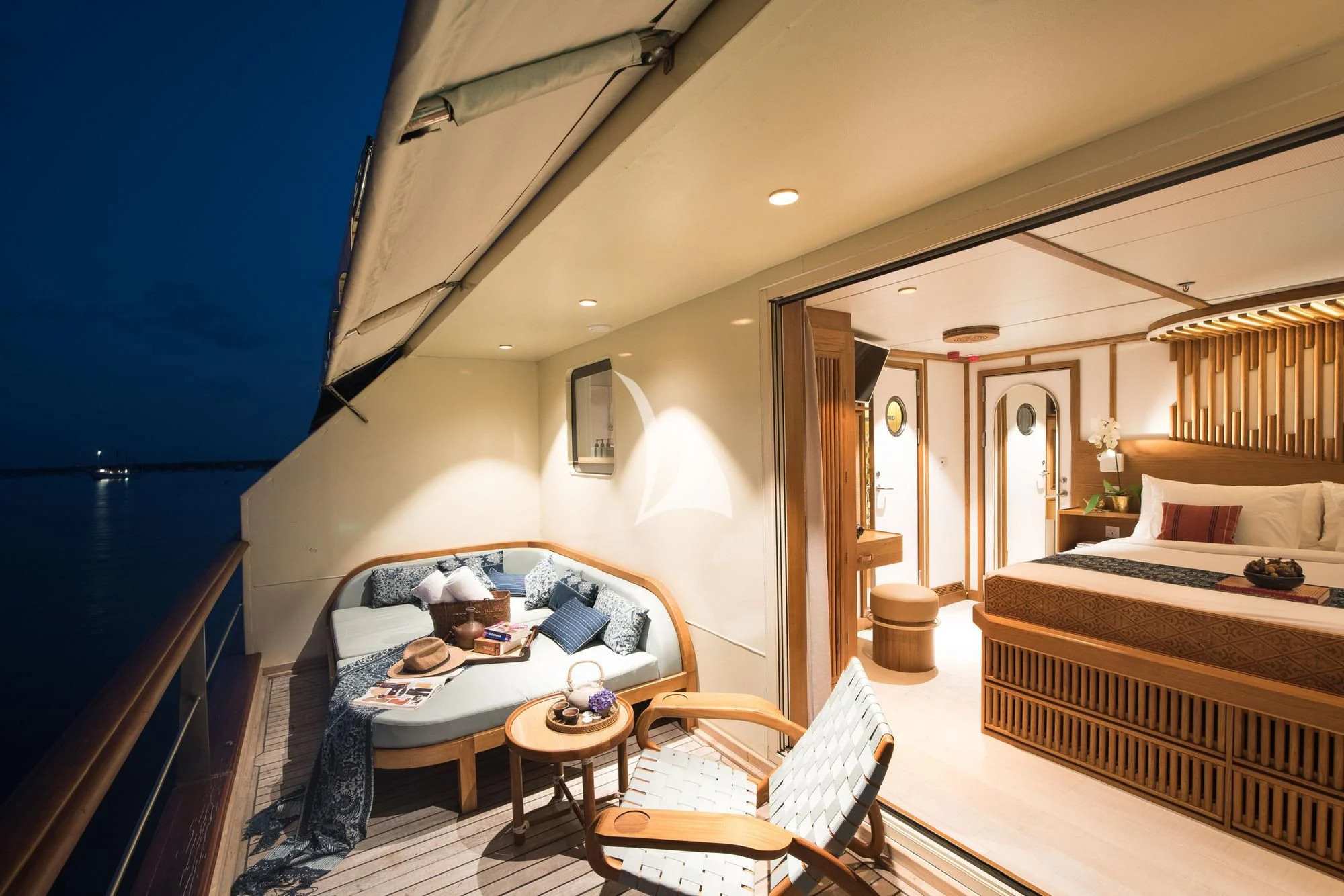 a bedroom with a bed and a table aboard KUDANIL EXPLORER Yacht for Sale