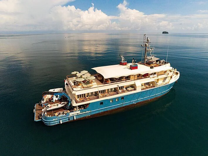 a large ship in the water aboard KUDANIL EXPLORER Yacht for Sale