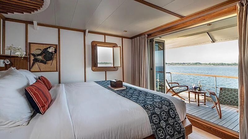 a bed with a white bed spread aboard KUDANIL EXPLORER Yacht for Sale