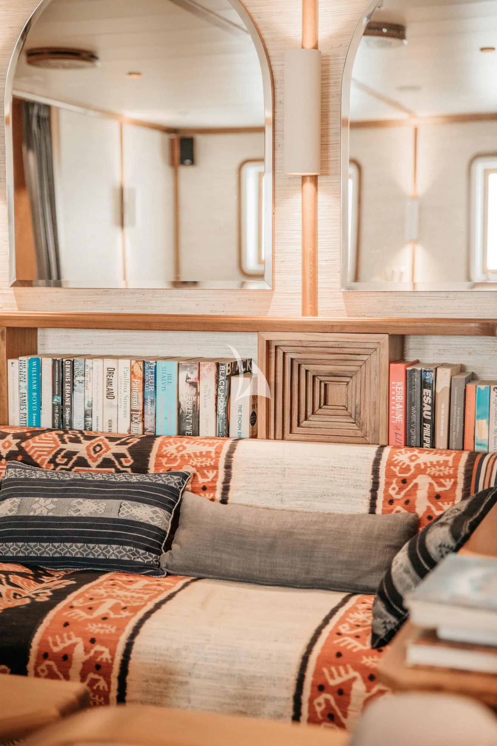 a room with books on shelves aboard KUDANIL EXPLORER Yacht for Sale