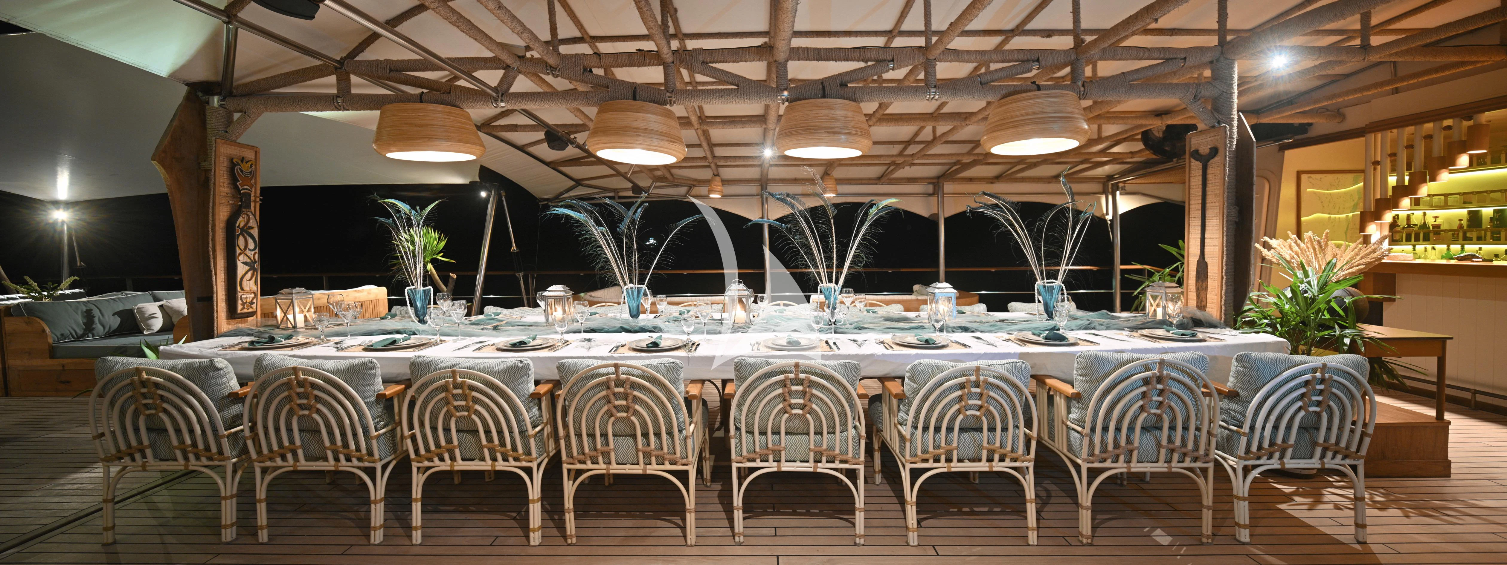 a large room with tables and chairs aboard KUDANIL EXPLORER Yacht for Sale