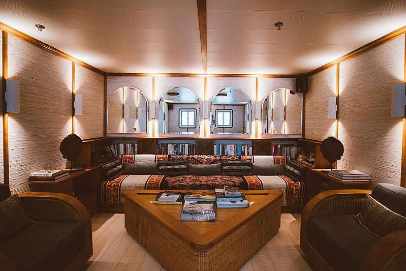 a room with a table and couches aboard KUDANIL EXPLORER Yacht for Sale
