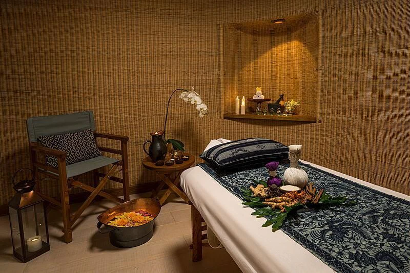 a room with a bed and a chair aboard KUDANIL EXPLORER Yacht for Sale