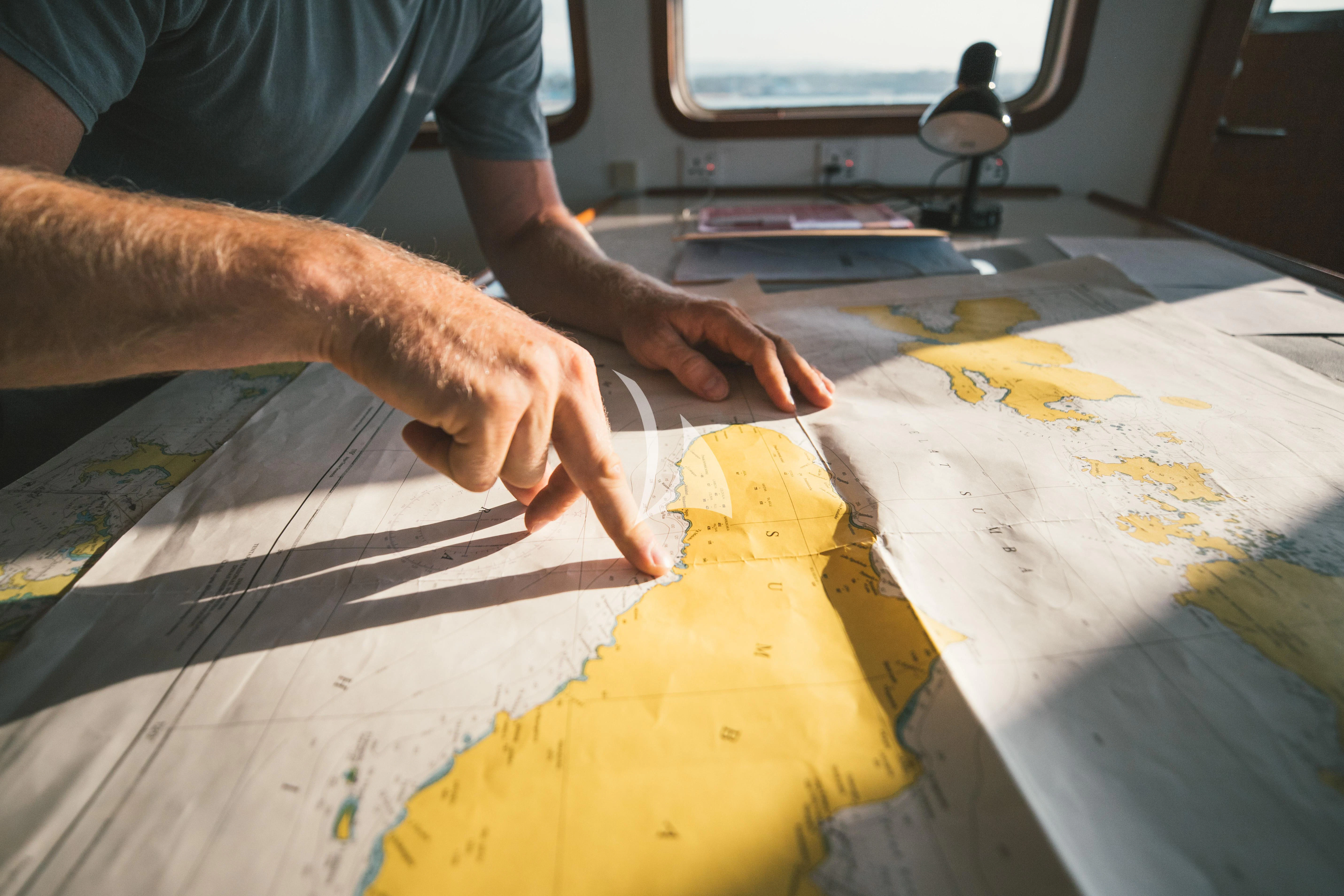 a person painting a yellow cloth aboard KUDANIL EXPLORER Yacht for Sale