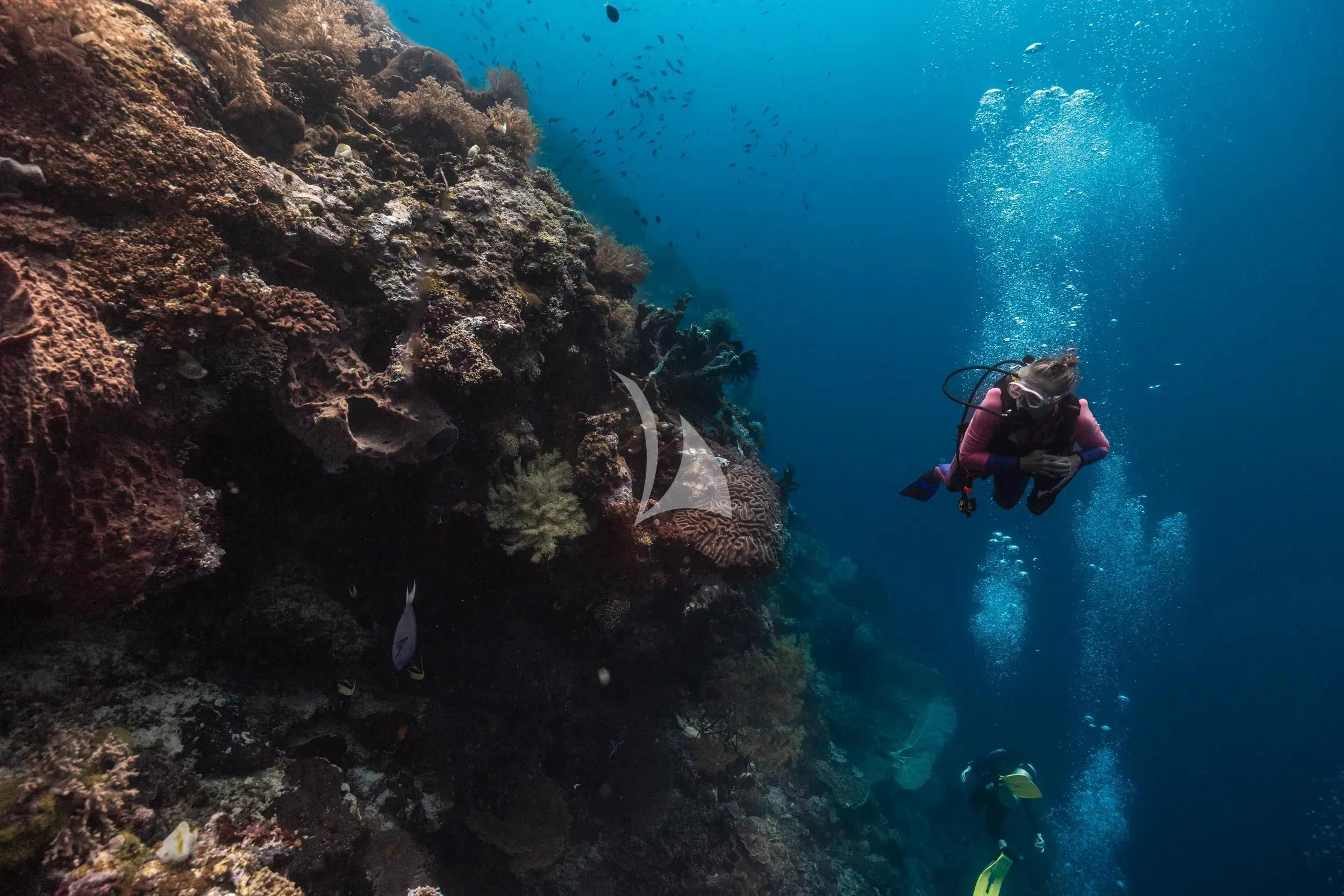a person in a kayak in the water aboard KUDANIL EXPLORER Yacht for Sale