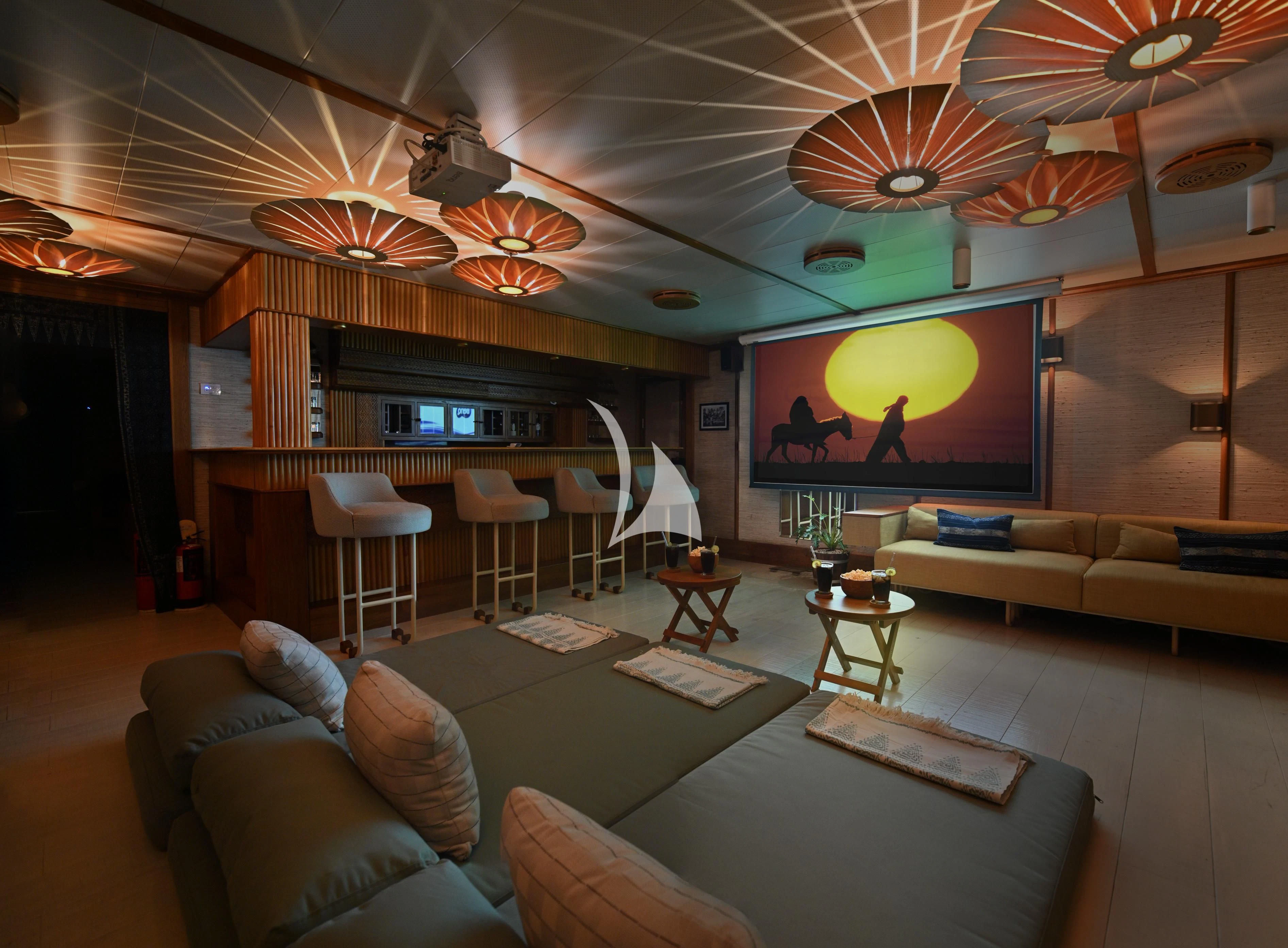 a living room with a large screen aboard KUDANIL EXPLORER Yacht for Sale