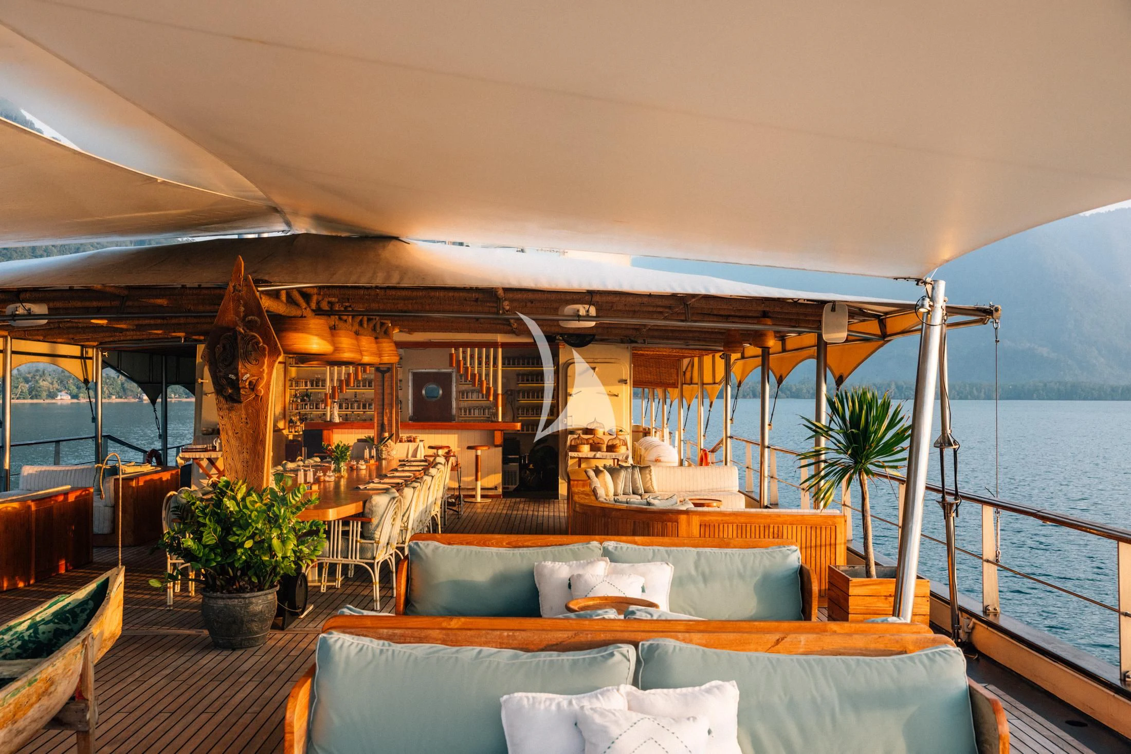 a room with a couch and a table and chairs aboard KUDANIL EXPLORER Yacht for Sale