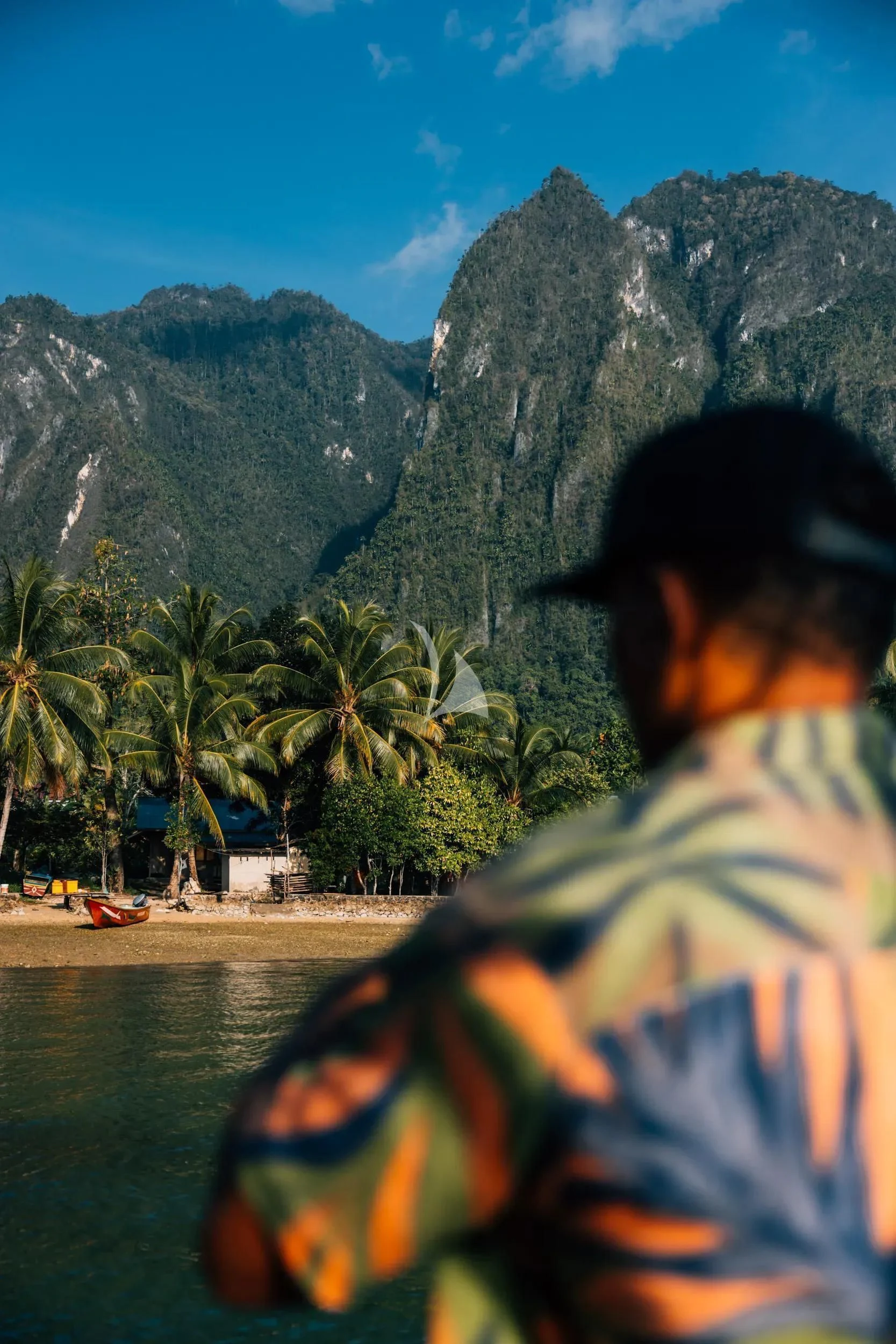 a person sitting on a boat in front of a rocky mountain aboard KUDANIL EXPLORER Yacht for Sale