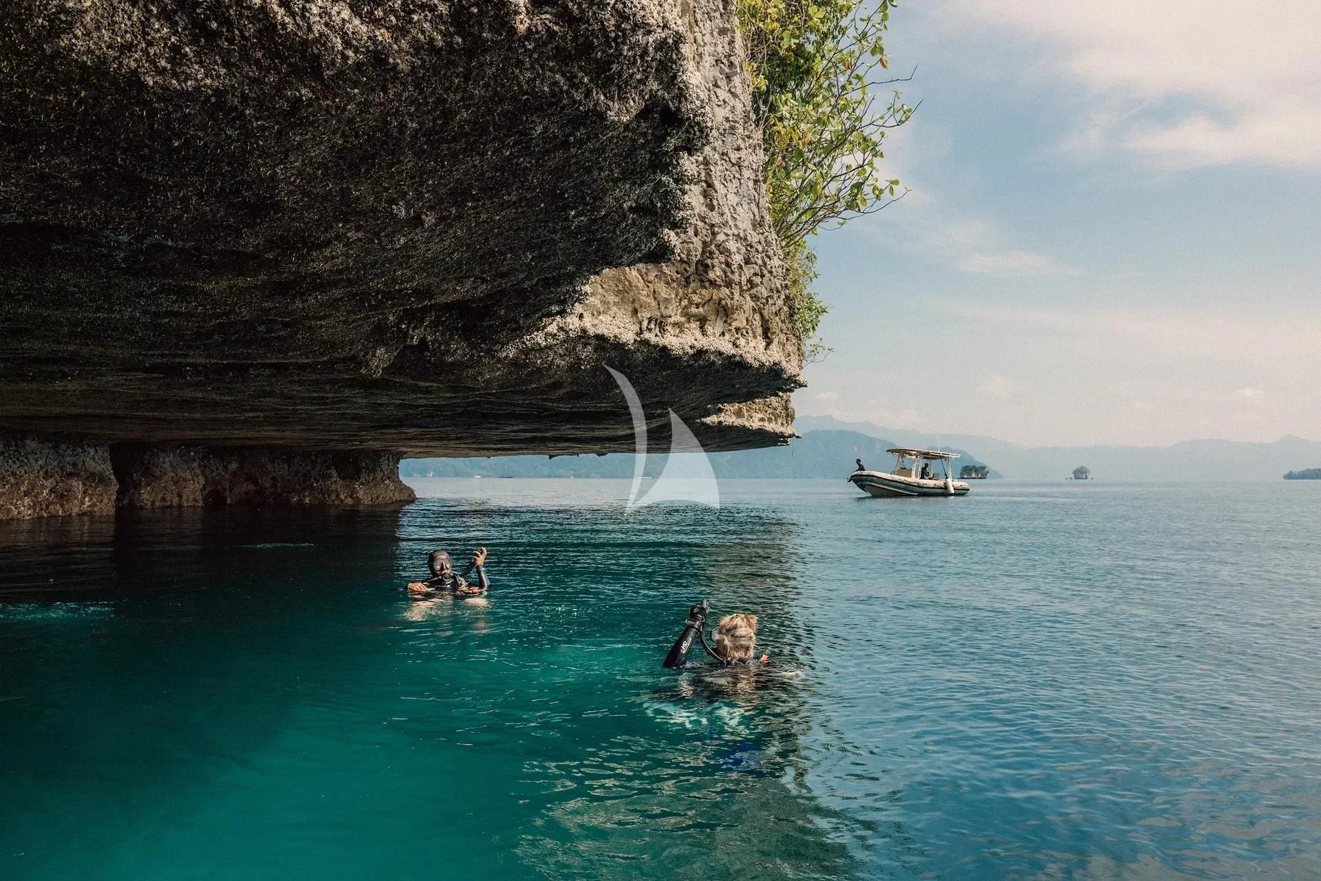 people swimming in a body of water aboard KUDANIL EXPLORER Yacht for Sale