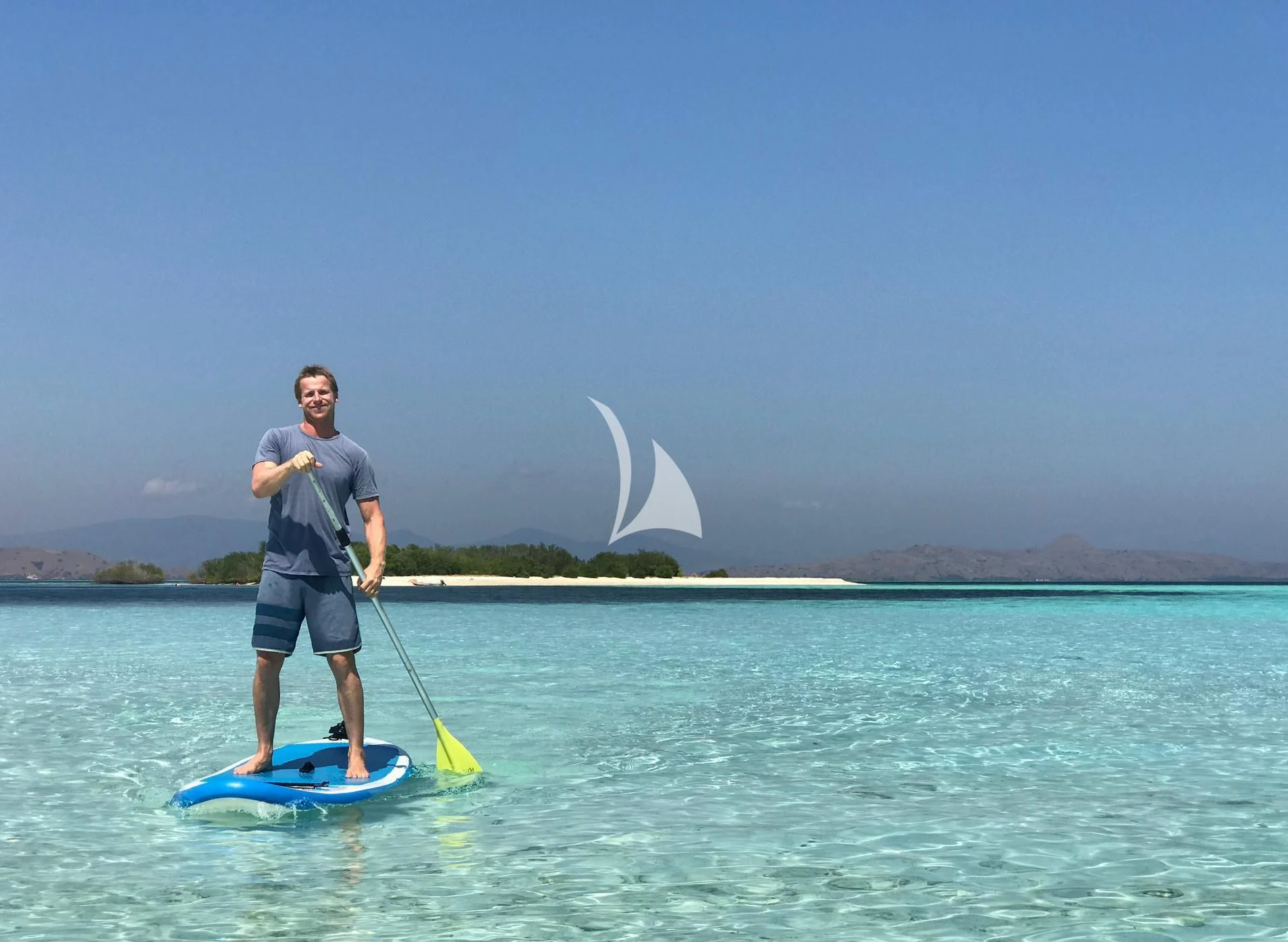 a man on a paddle board aboard KUDANIL EXPLORER Yacht for Sale