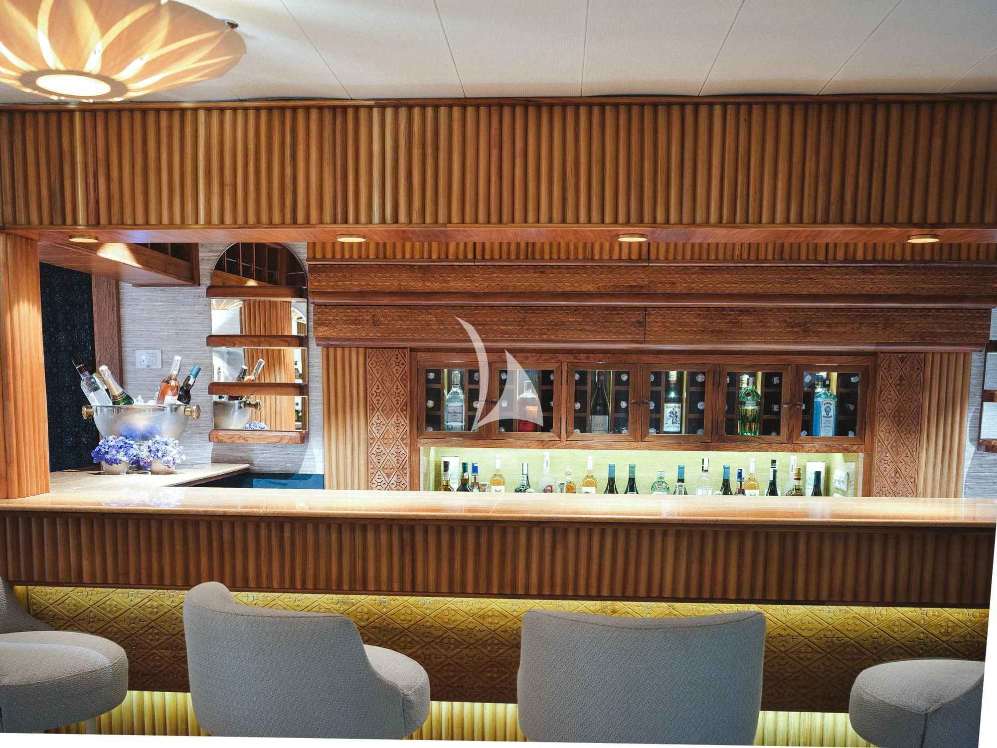 a bar with shelves and chairs aboard KUDANIL EXPLORER Yacht for Sale