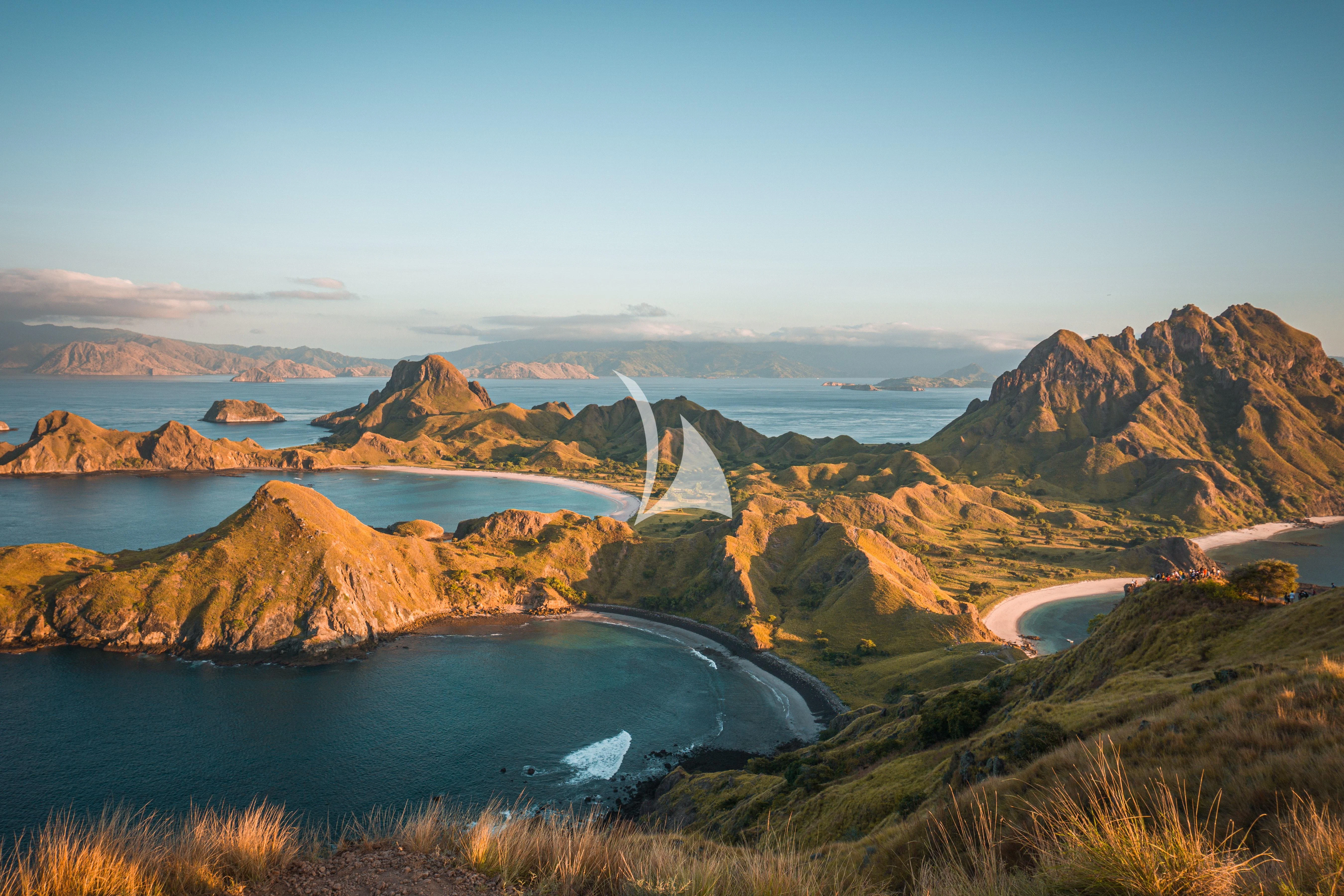 a body of water with mountains in the background aboard KUDANIL EXPLORER Yacht for Sale