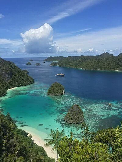 a body of water with islands and boats in it aboard KUDANIL EXPLORER Yacht for Sale