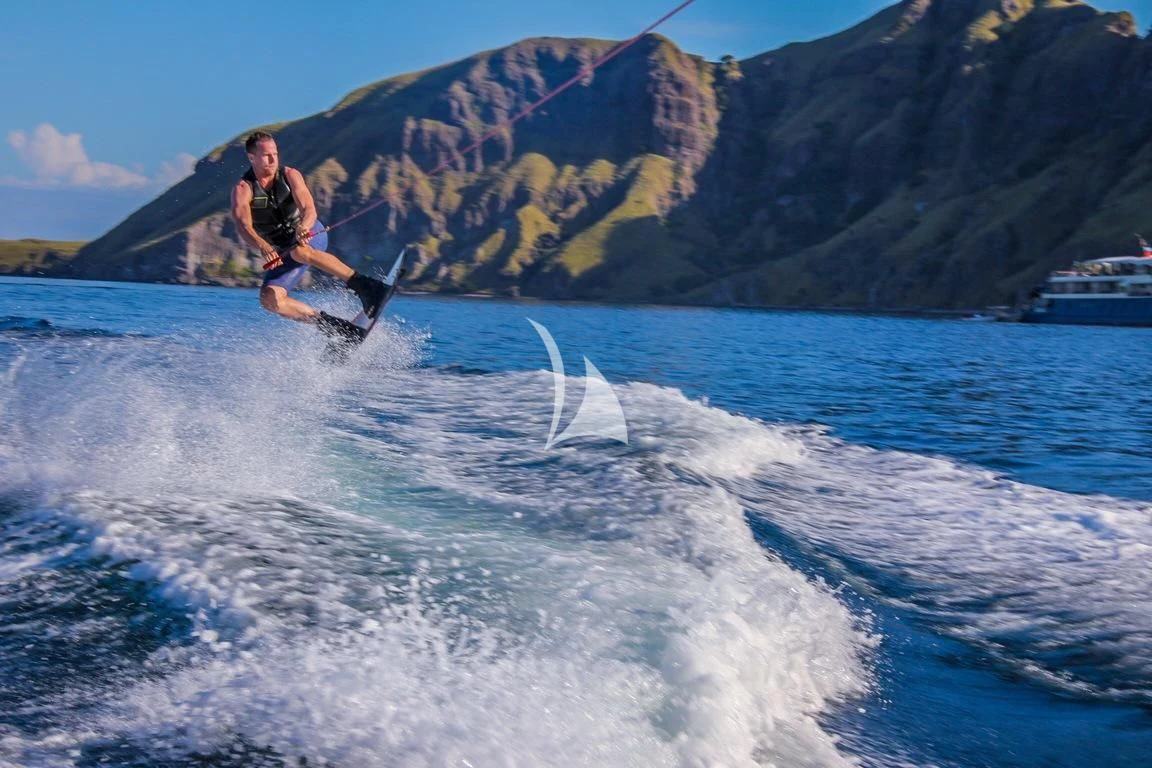 a man water skiing aboard KUDANIL EXPLORER Yacht for Sale