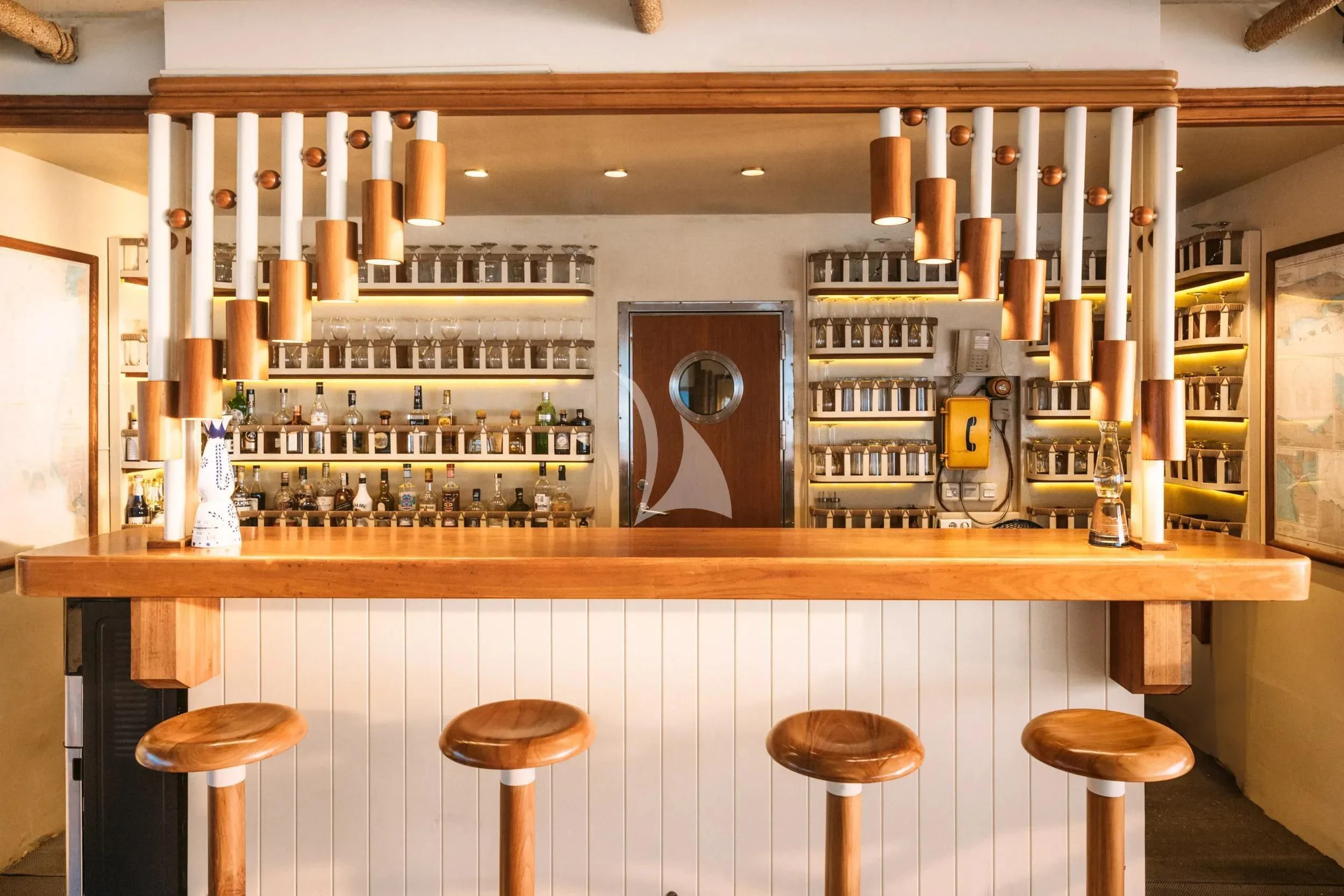 a kitchen with a bar and stools aboard KUDANIL EXPLORER Yacht for Sale