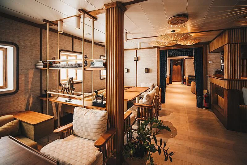 a room with a desk and chairs aboard KUDANIL EXPLORER Yacht for Sale