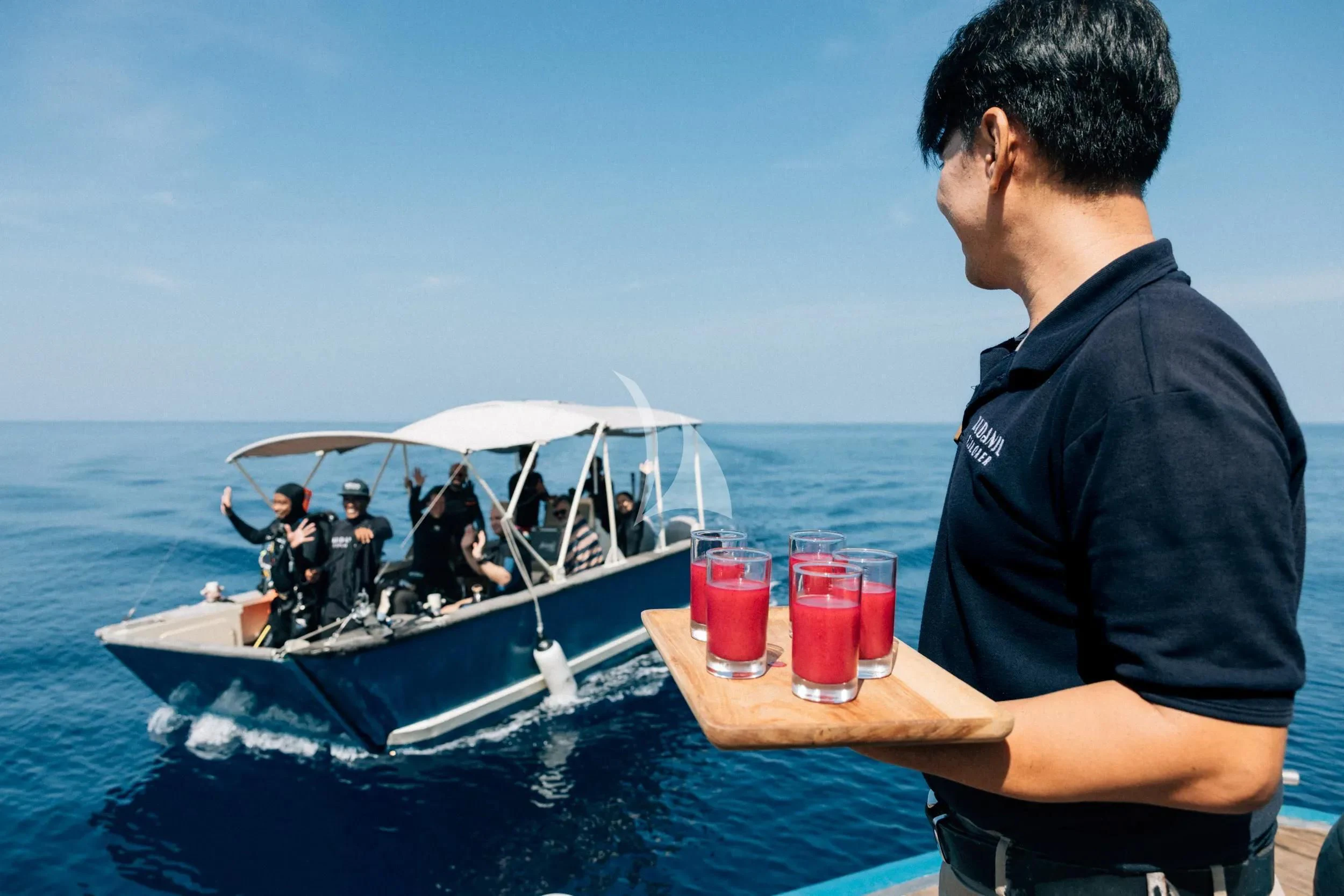 a man looking at a paper on a boat aboard KUDANIL EXPLORER Yacht for Sale