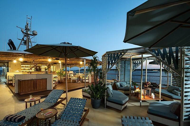 a patio with a table and chairs aboard KUDANIL EXPLORER Yacht for Sale