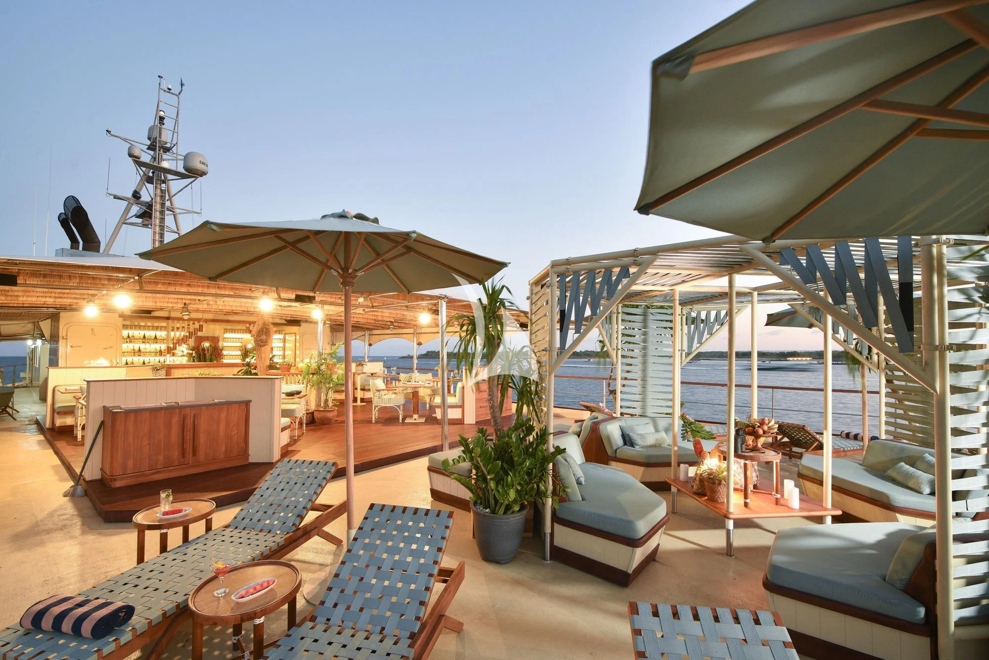 a patio with a table and chairs aboard KUDANIL EXPLORER Yacht for Sale