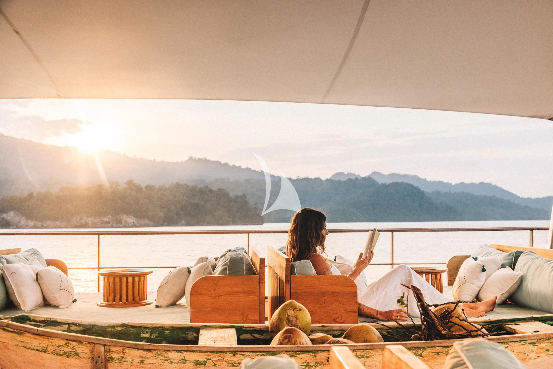 a person sitting on a couch aboard KUDANIL EXPLORER Yacht for Sale
