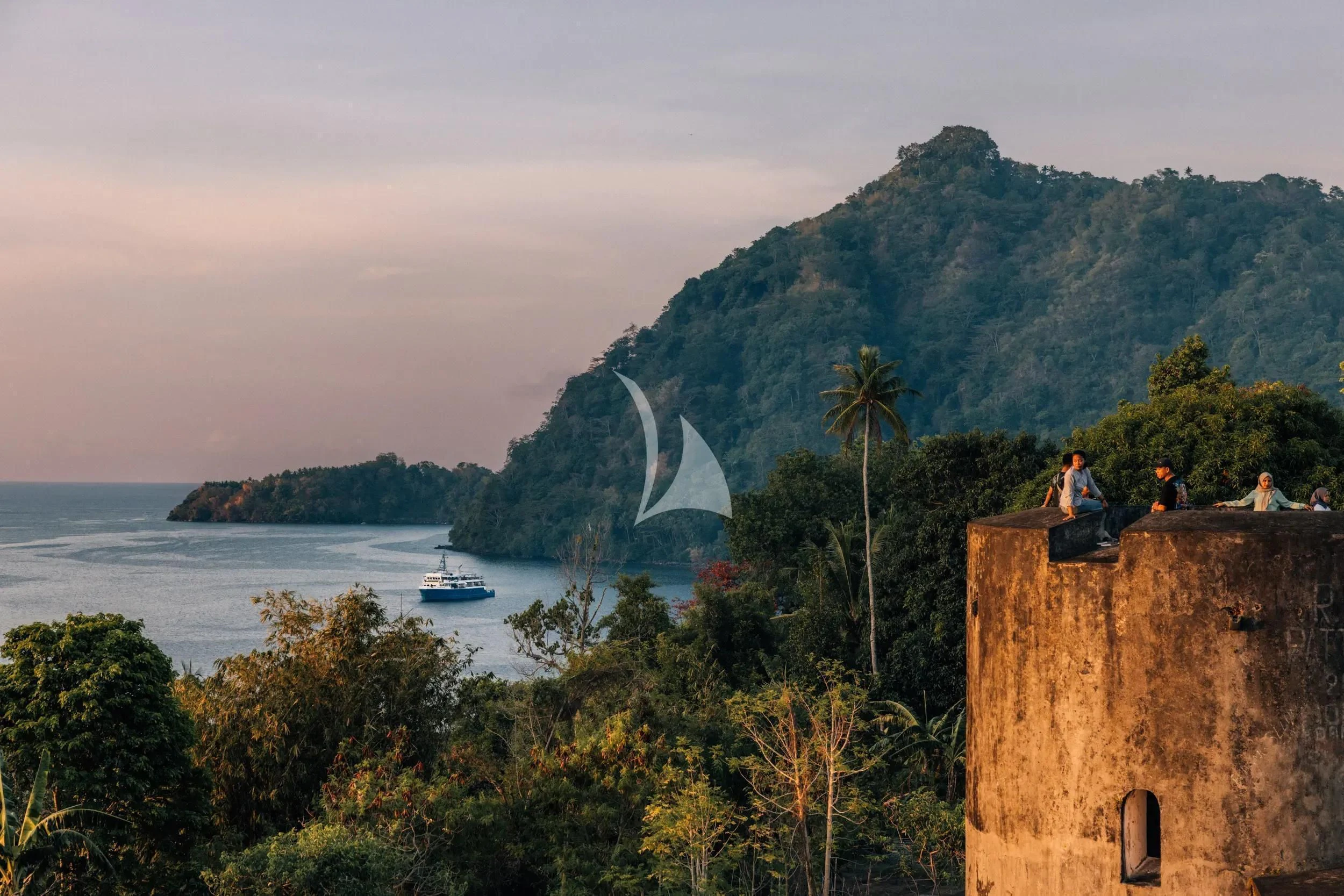 a building on a cliff overlooking a body of water aboard KUDANIL EXPLORER Yacht for Sale