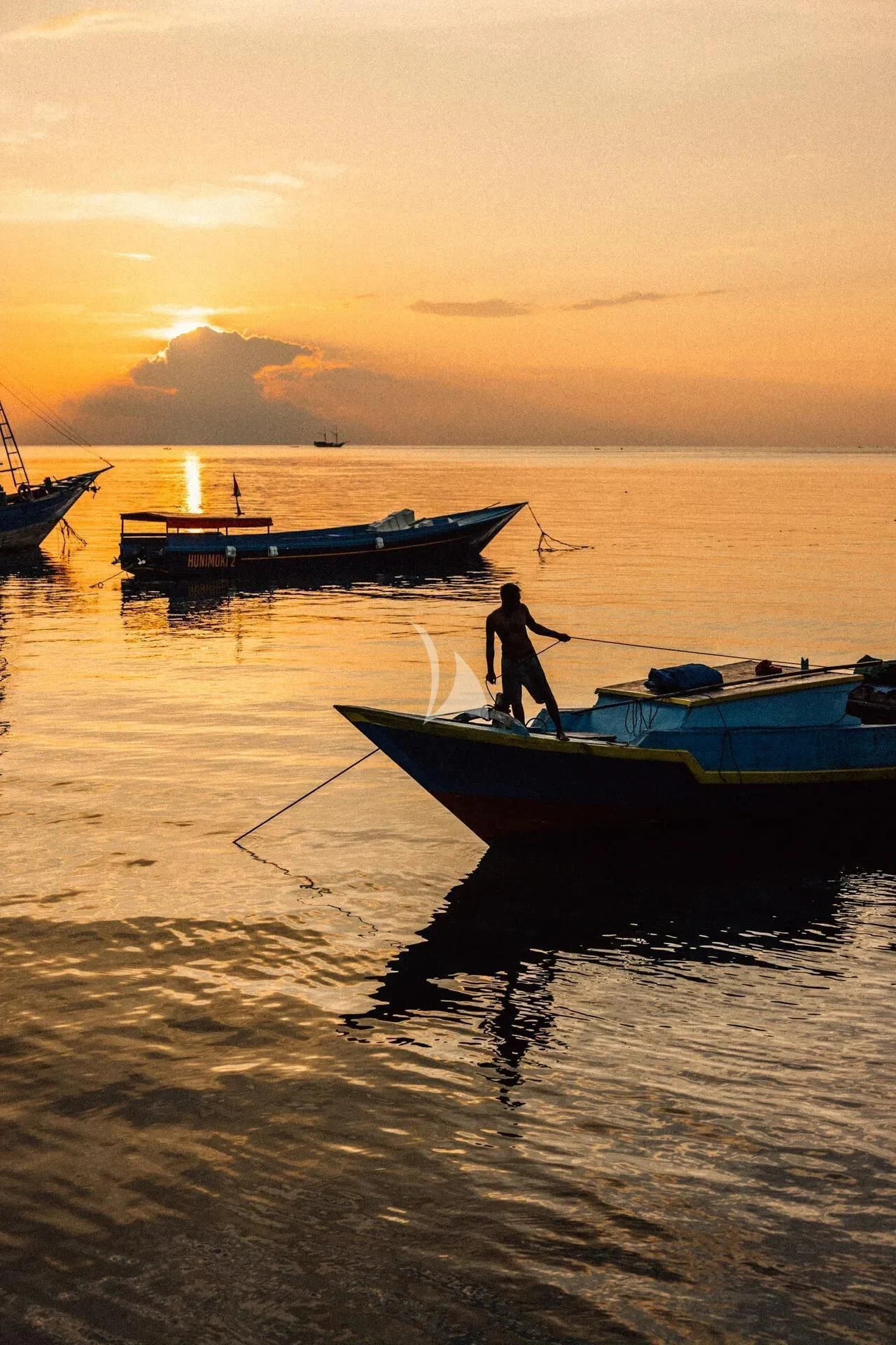 a person standing on a boat in the water aboard KUDANIL EXPLORER Yacht for Sale