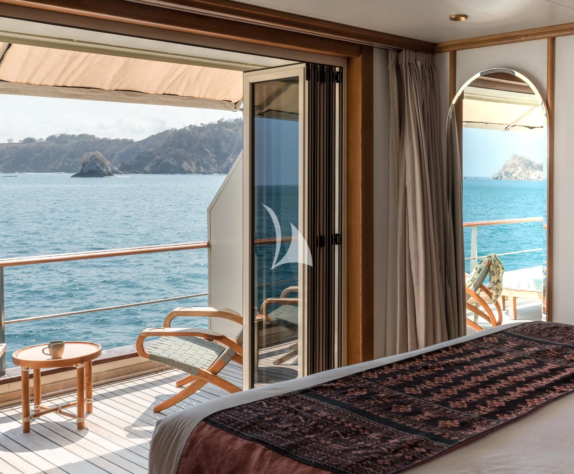 a room with a view of the water and mountains aboard KUDANIL EXPLORER Yacht for Sale