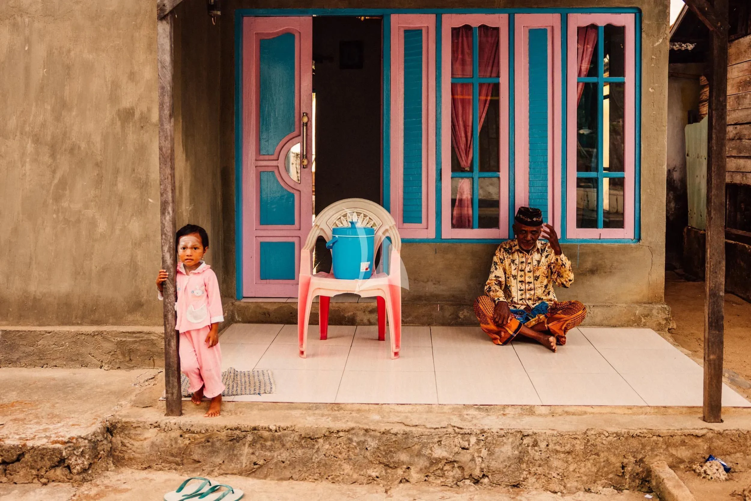 a child and an older woman sitting outside a building aboard KUDANIL EXPLORER Yacht for Sale