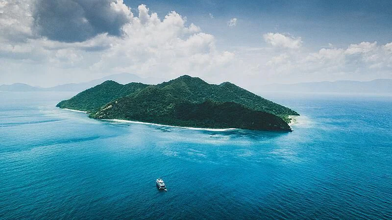 a small island in the ocean aboard KUDANIL EXPLORER Yacht for Sale