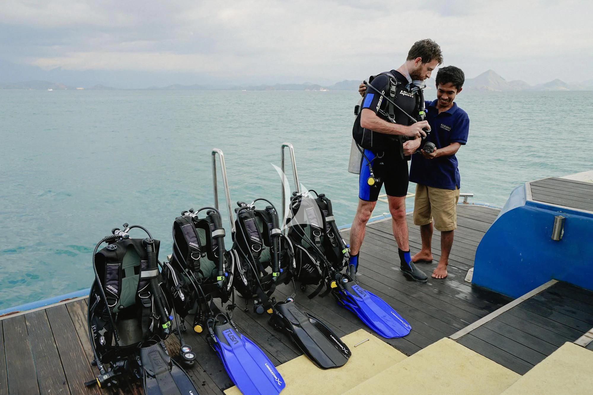 two boys standing on a boat with scuba gear aboard KUDANIL EXPLORER Yacht for Sale
