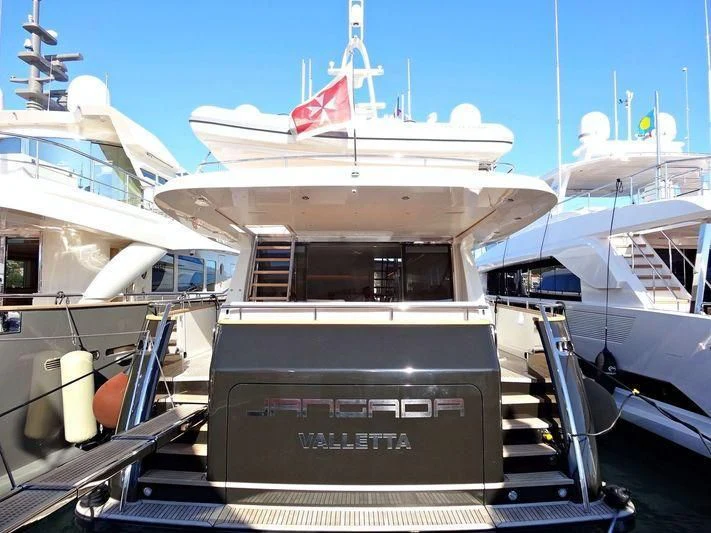 a boat with a flag on the front aboard MR. MAVERICK Yacht for Sale