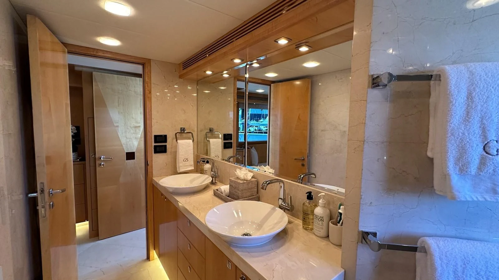 a bathroom with a countertop sink and a large mirror aboard SALVATORE II Yacht for Sale