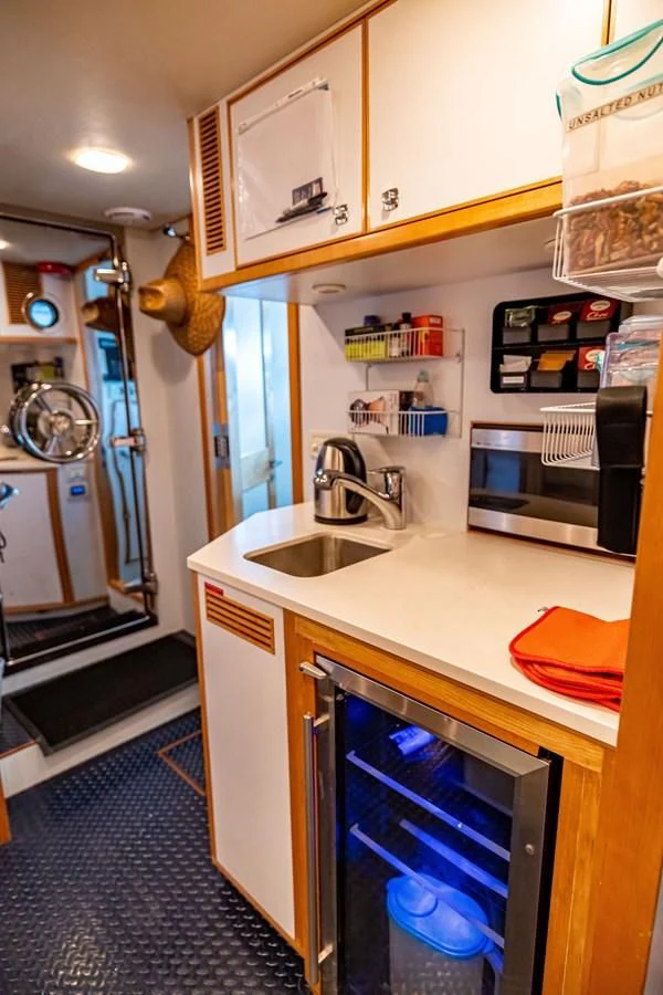 a kitchen with a sink and microwave aboard SALVATORE II Yacht for Sale