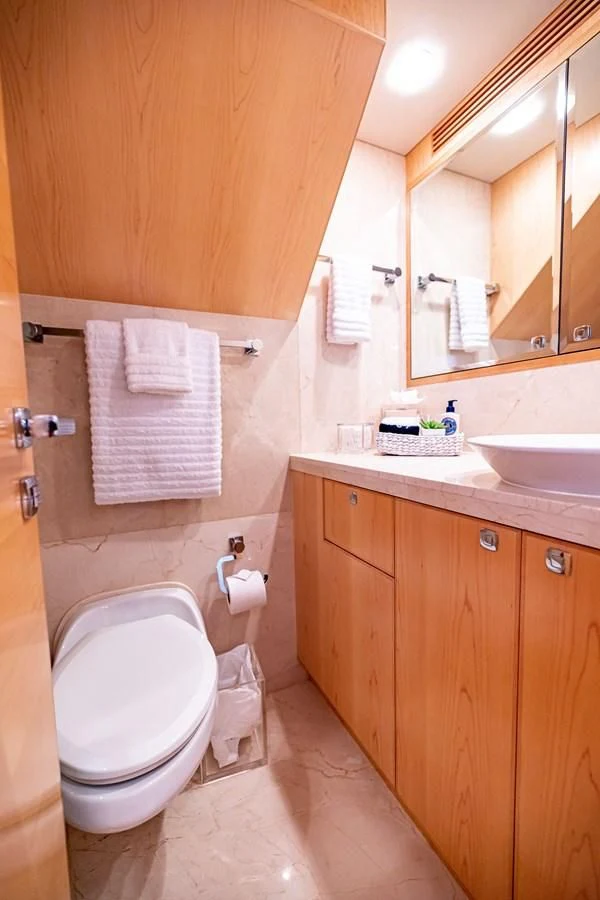a bathroom with a toilet and a sink aboard SALVATORE II Yacht for Sale