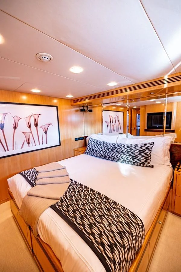 a bedroom with a couple of beds aboard SALVATORE II Yacht for Sale