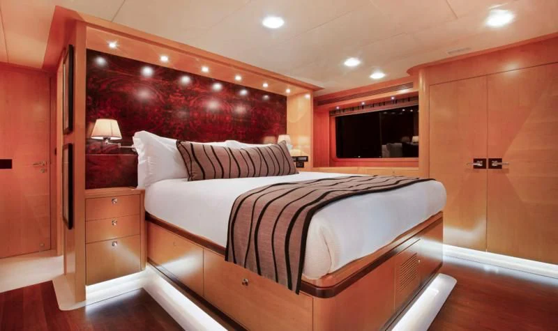 a bedroom with a bed and a desk aboard SALVATORE II Yacht for Sale