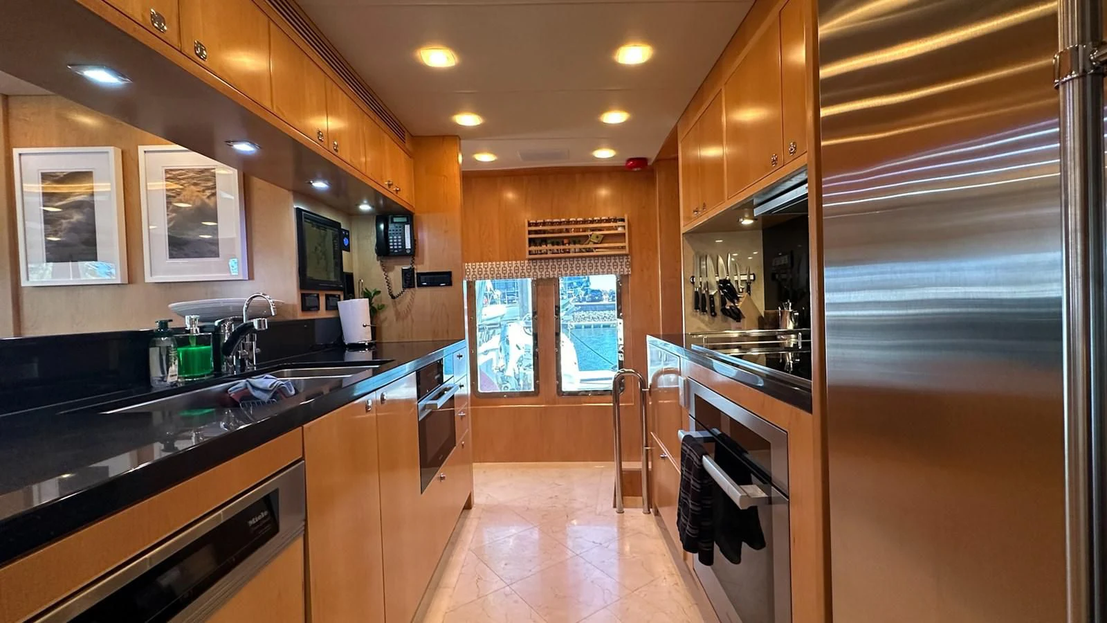 a kitchen with a large refrigerator aboard SALVATORE II Yacht for Sale