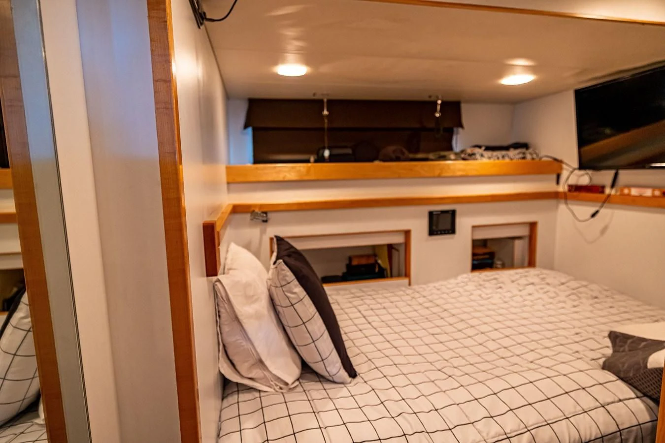 a room with a bed and a television aboard SALVATORE II Yacht for Sale