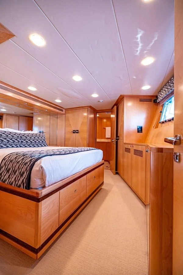 a bedroom with a bed and a closet aboard SALVATORE II Yacht for Sale