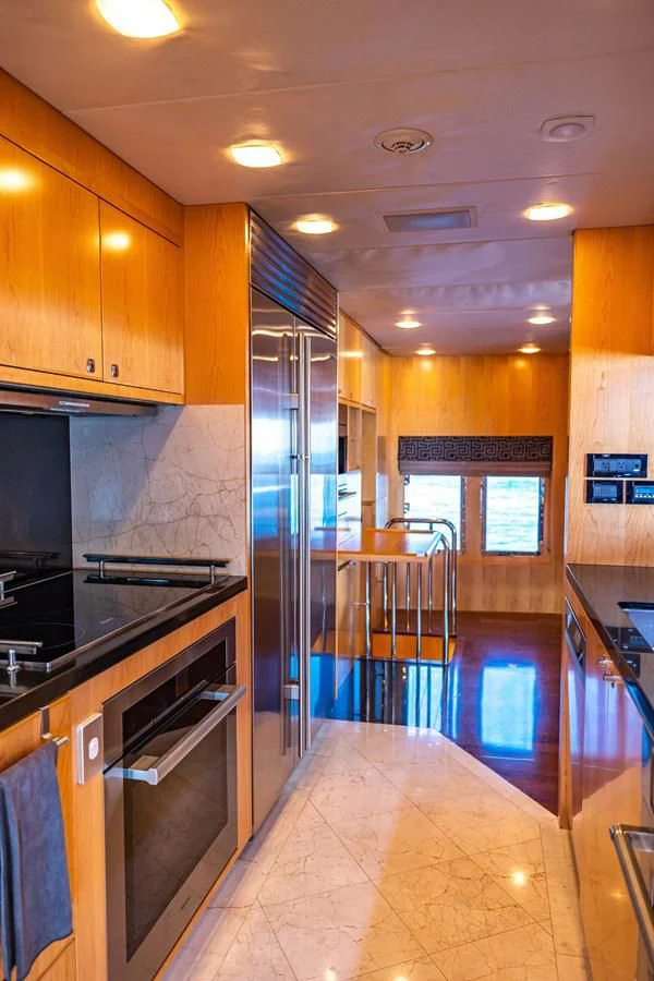 a kitchen with a large glass door aboard SALVATORE II Yacht for Sale